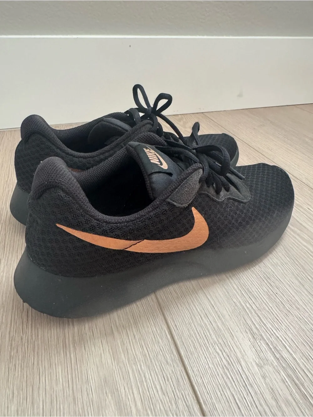 Nike womens Black Sneakers with Copper Swoosh Accent